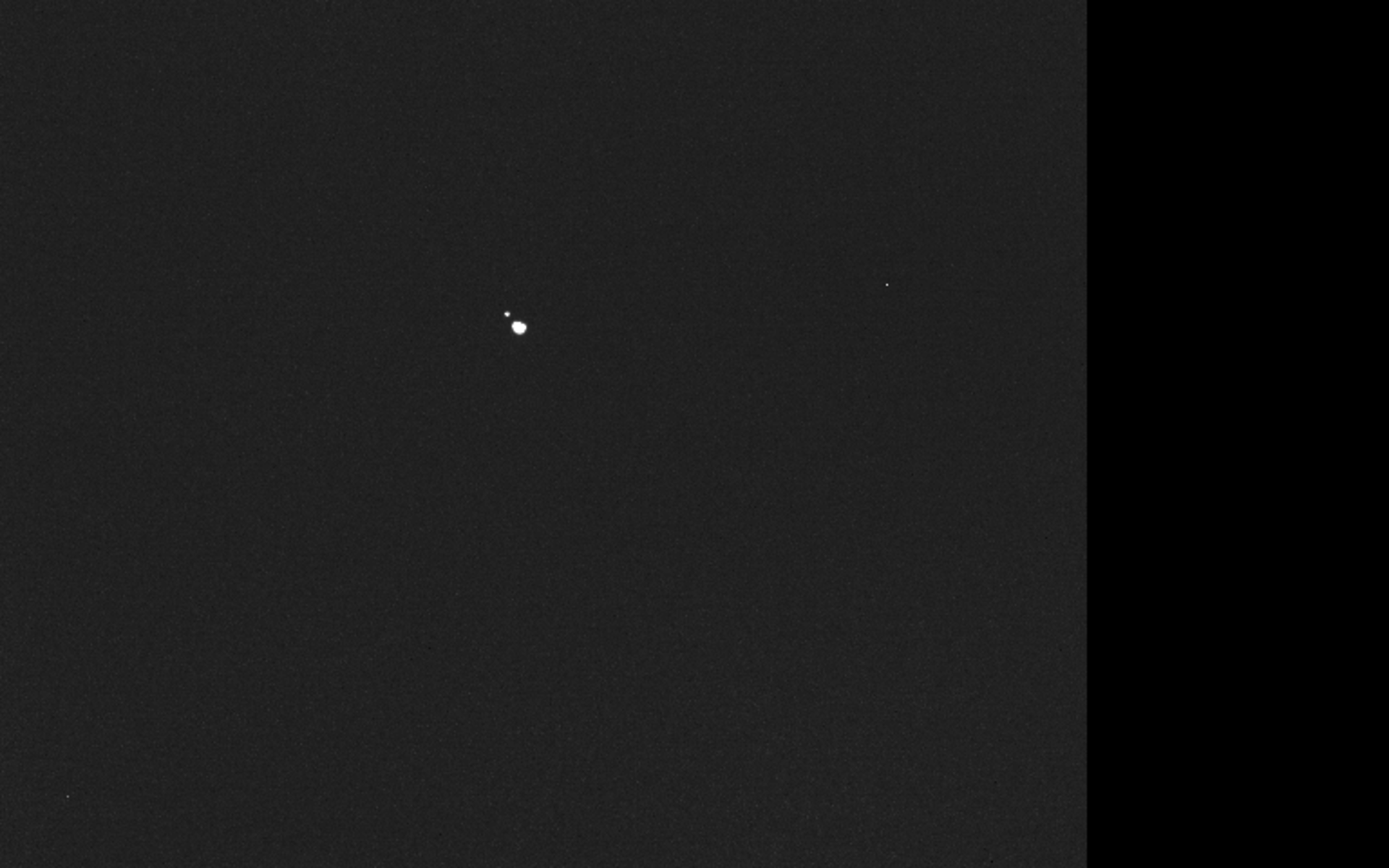 Two bright objects against a dark star field: asteroids Didymos and Dimorphos imaged by Hera.